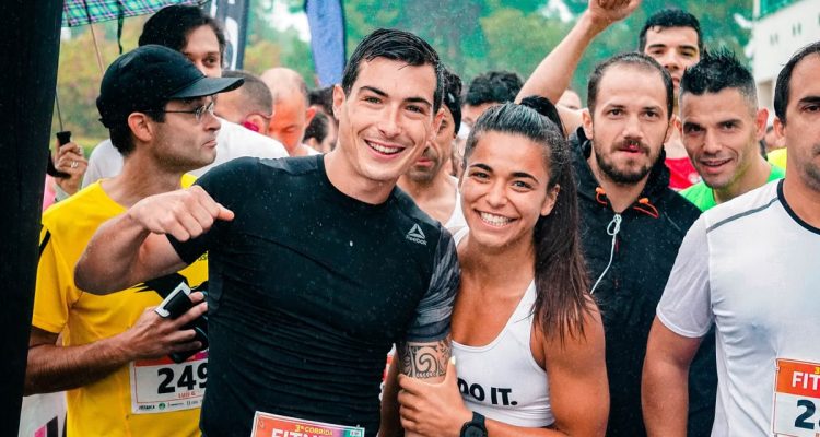 Group of runners smiling in the rain during a marathon race event.